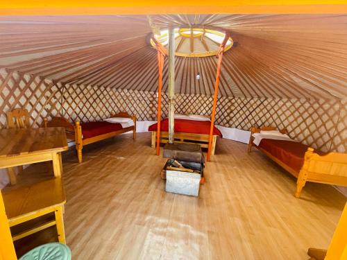 a room with several beds in a yurt at Tungalag tamir tourist camp 
