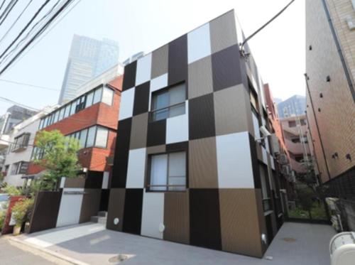 a building with a checkered wall on the side of it at Roppongi Place in Tokyo