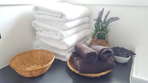 a pile of towels and a basket on a counter at Ruapehu Mountain Motel & Lodge in Ohakune