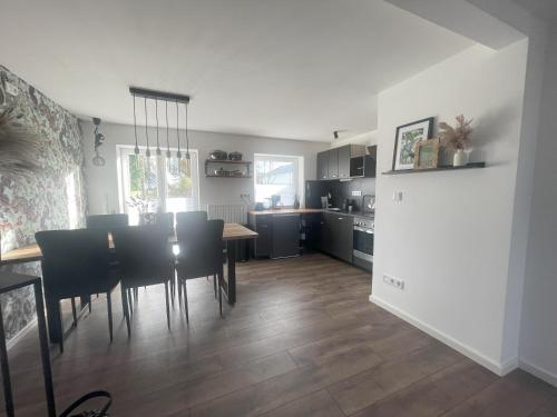 a kitchen and dining room with a table and chairs at GRYT Home - FeWo XXL - Nähe Nordsee in Ramhusen