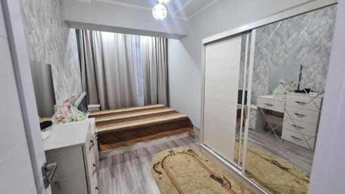 a bedroom with a bed and a walk in shower at Квартира в новом жилом комплексе Invest House in Tashkent