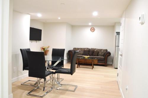 a dining room with a table and black chairs at Secondary Suite, Separate Entrance NW Calgary in Calgary