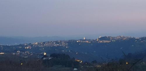 a view of a mountain with houses and trees at Alto Locandieri in Montebagnolo