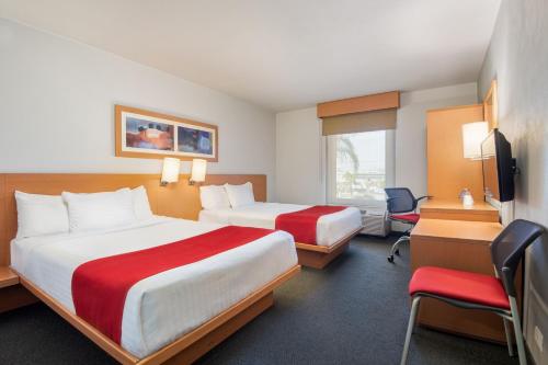 a hotel room with two beds and a desk at City Express by Marriott Tepotzotlán in Tepotzotlán