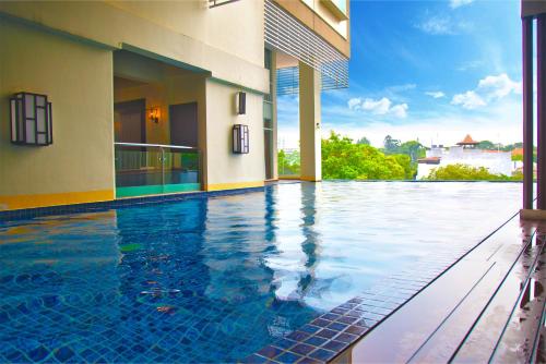 a swimming pool in the middle of a building at De Paviljoen Bandung in Bandung