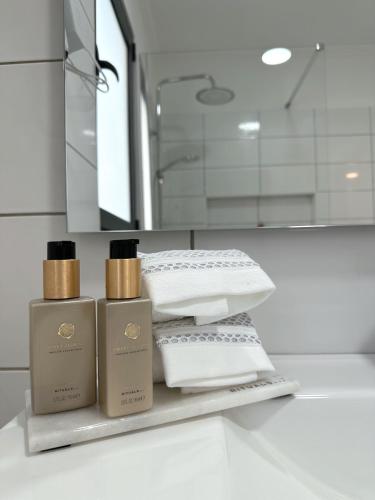 a bathroom with three bottles ofodorizers on a shelf at Madeiran Sweet Home in Funchal