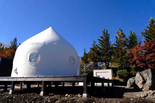 a white dome tent sitting on top of a bench at LCO-Resort in Takizawa
