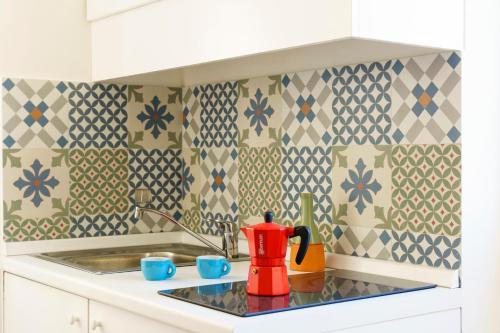 a kitchen counter with a red coffee pot on it at Palazzo Olivieri Amalfi Coast in Salerno
