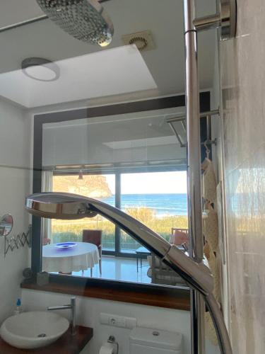a bathroom with a mirror and a sink and a table at Vistas Increibles in Las Negras