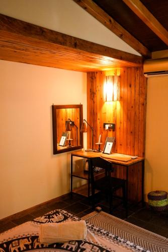 a room with a desk with a laptop on it at Sapana Village Lodge in Sauraha