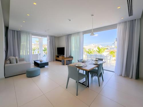 a living room with a table and chairs and a couch at City Napa Seaview Villas - Villa 7 in Ayia Napa