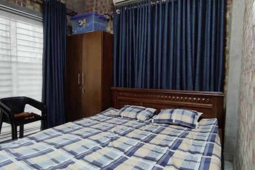 ein Bett mit zwei Kissen in einem Schlafzimmer mit einem Vorhang in der Unterkunft YJ Homes 