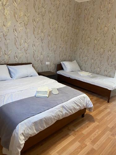 a room with two beds and a wall at Yeghevni Guest House in Odzun in Odzun