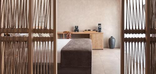 a bedroom with a bed and a desk in a room at Helea Lifestyle Beach Resort in Kallithea Rhodes