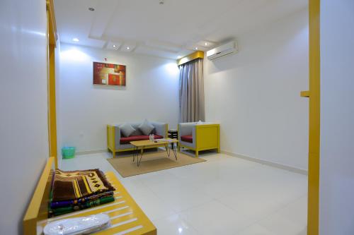 a living room with a couch and a table at Hosta Serviced Apartments Al Malqa in Riyadh