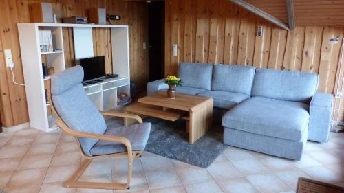 a living room with a couch and a table at Ferienhaus Horizont in Kobbellück