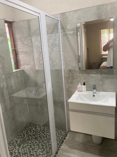 a bathroom with a shower and a sink at Tinroofs Cottage in Kelso