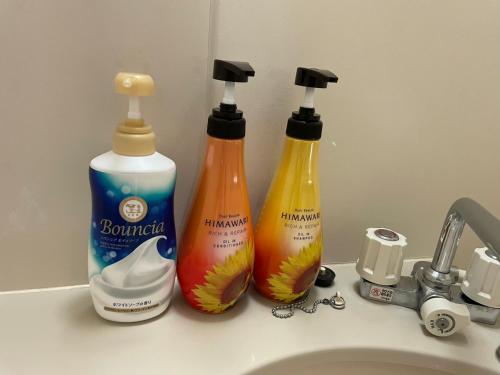 three bottles of cleaning products sitting on a sink at Tokyo Stay Waseda in Tokyo