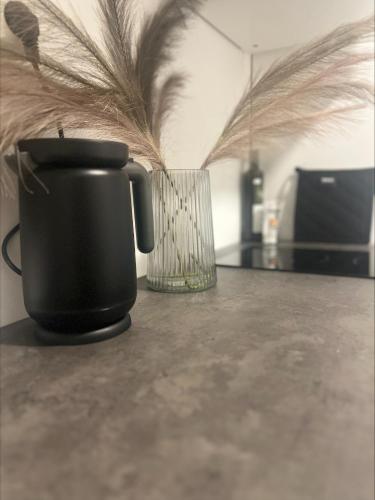 a black coffee mug and a glass on a table at Gamle Oslo Apartments in Oslo