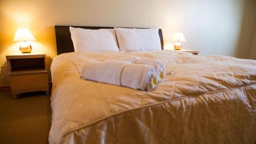 Ένα ή περισσότερα κρεβάτια σε δωμάτιο στο Niseko Alpine Apartments