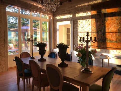 a dining room with a wooden table and chairs at Domaine en Reynouse in Pierreclos