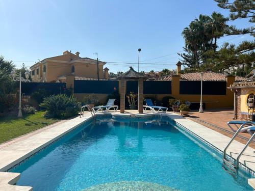 a swimming pool in front of a house at Casa Beatriz V in Rincón de la Victoria