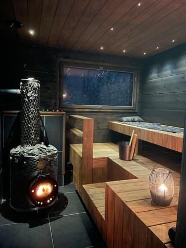 a sauna with a woodburning stove in a room at Silencius Cabin With Private Jacuzzi in Rovaniemi