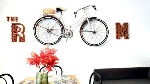 a bike hanging on a wall next to a table at THE ROOM - APARTMENT IN LLORET in Lloret de Mar