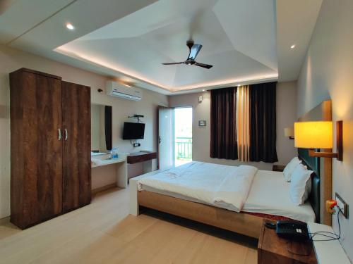 a bedroom with a bed and a ceiling fan at The Kanila Resort in Karjat