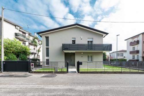 a white house with a black roof at Italstay - Guerrazzi New Flat - Parcheggio privato in Padova