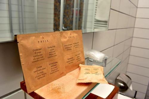 a menu sitting on top of a counter in a bathroom at Betsy"s hotel in Tbilisi City