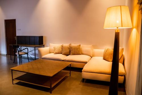 a living room with a couch and a table at Lily Pod in Panadura