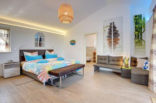 un dormitorio con una cama y un sofá en Villa Sunset, en Bužinija