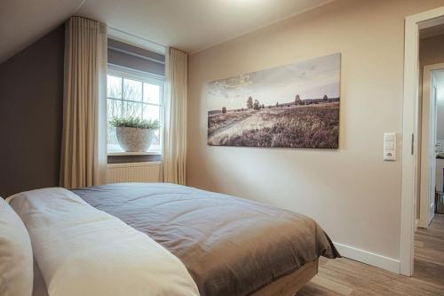 um quarto com uma cama e um quadro na parede em Schicke Bude em Soltau