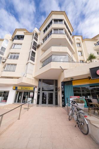 a building with a bike parked in front of it at Sea View Apartment Albir Playa Mar in Albir