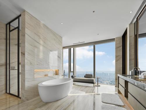 a bathroom with a tub and a view of the city at Hilton Zhuji in Zhuji