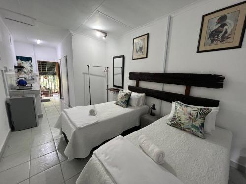 a hotel room with two beds and a kitchen at Sister's Haven in Nelspruit