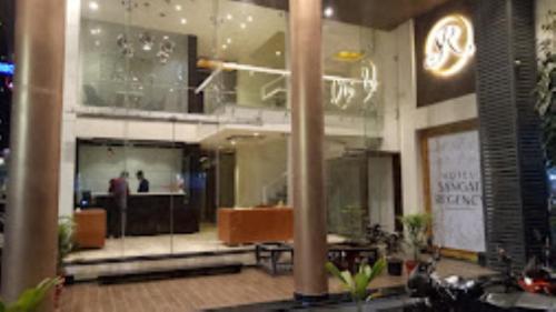 a lobby of a building with people in it at Hotel Sangat Regency in Bhopal