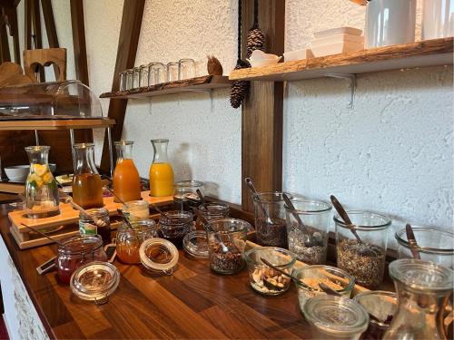 a wooden table with jars of food on it at Pension Himmelreich in Glatt