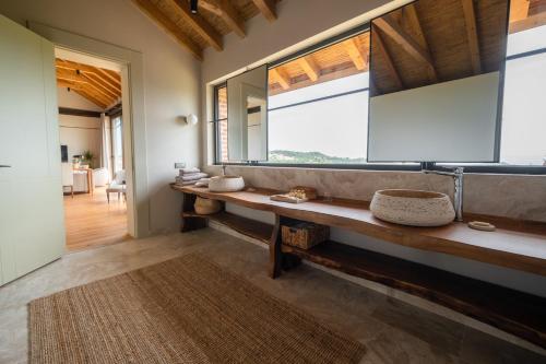 a bathroom with a sink and a large window at MANİCİ ÇİFTLİK in Ayvacık