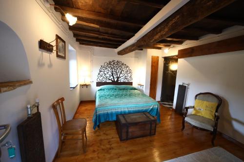 a bedroom with a bed with a tree headboard at Col di Lana in Rocca di Botte