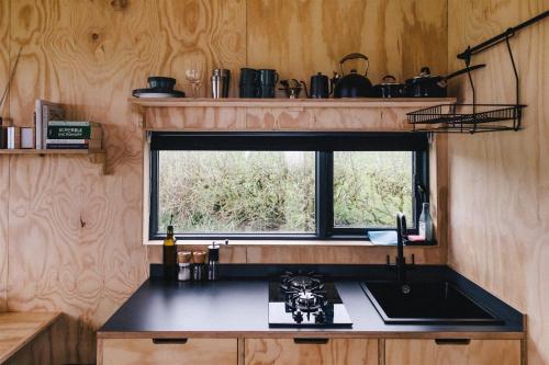 a kitchen with a sink and a window at Teal in Kelsall