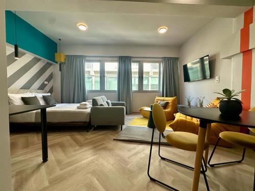 a bedroom with a bed and a living room at Ermou funky lofts in Athens