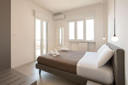 a bedroom with a large bed with two towels on it at Luxury Cefalù Santa Maria in Cefalù