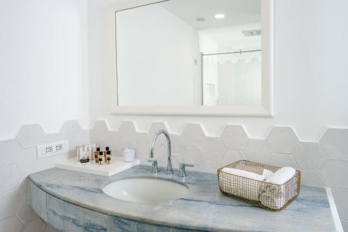 a bathroom with a sink and a mirror at Hotel Belair in Sorrento