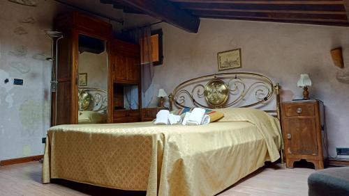 a bedroom with a bed with two towels on it at Relais Corso Storico in Pisa