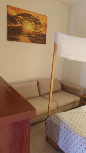 a living room with a couch and a bed at Vue sur l'Atlantique in Cotonou