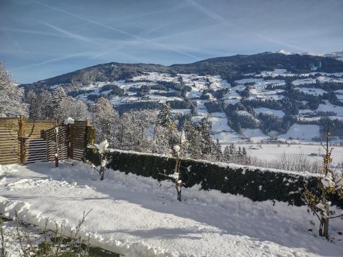 a view of a snow covered mountain in the distance at Ferienwohnung Familie Fiechtl in Fügenberg