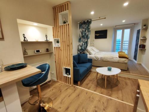 - un salon avec une chaise bleue et un lit dans l'établissement Studio vieille ville tout équipé sans ascenseur, à Menton