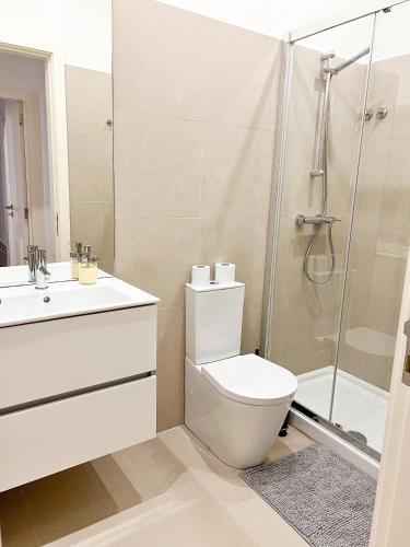a bathroom with a shower and a toilet and a sink at Room in the Heart of Historic Lisbon on Rua Augusta in Lisbon